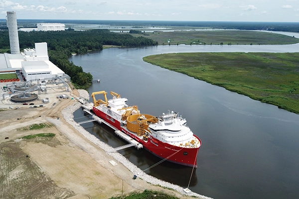 Large red ship docked in the Cooper River