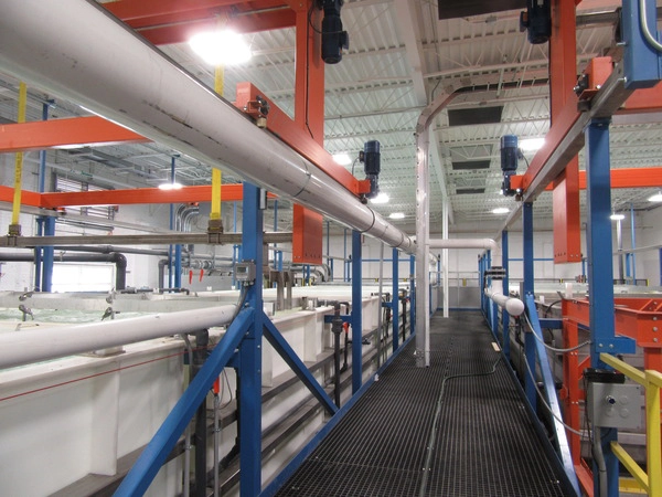 Large white pipes with orange and blue steel support