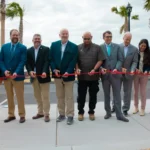 Group gathered for ribbon cutting at low battery seawall